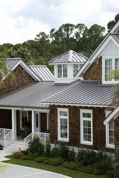 a house with metal roofing and white trim on the front door is shown in an instagram