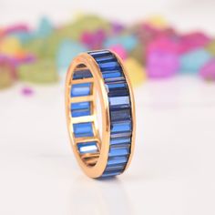 a gold ring with blue stones on it