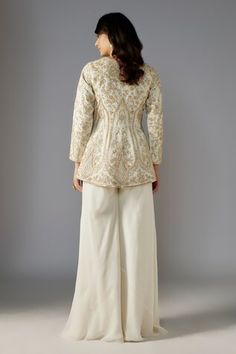 Ivory peplum jacket with sequin bead embellished floral swirl patterns. Comes with solid sharara. - Aza Fashions Traditional Cream Long Sleeve Palazzo Set, Traditional Cream Palazzo Set With Long Sleeves, White Palazzo Set With Intricate Embroidery And Long Sleeves, White Long Sleeve Palazzo Set With Intricate Embroidery, Traditional Long Sleeve Cream Palazzo Set, Traditional Long Sleeve Cream Sharara, Wedding Nehru Jacket With Gota Work And Long Sleeves, Long Sleeve Palazzo Set With Chikankari Embroidery For Reception, Beige Long-sleeve Palazzo Set With Chikankari Embroidery