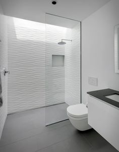 a bathroom with a white toilet sitting next to a sink