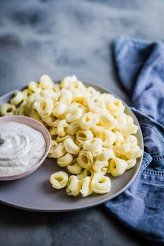 a plate full of macaroni and cheese with dip