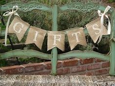 a green bench that has some burlocks on it with the word gifts written on it