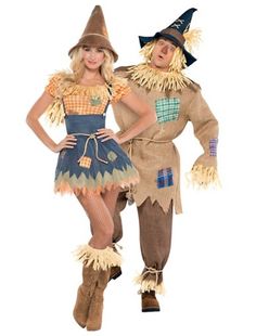 two people dressed in costumes standing next to each other on a white background and one is wearing a scarecrow costume