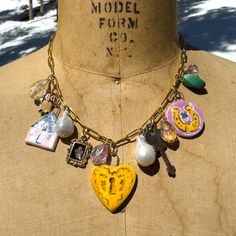 "Unlock Your Fairytale Cottage" -Ceramic Charm Necklace I felt such excitement when I was creating these little charms out of clay. Each charm began with a story of patience, as I was learning a new medium. These charms are made with dreams, love and lots of time. This is a handmade porcelain pendant. Fired twice in a kiln and glaced with underglazes under a transparent glossy glaze. It hangs on a high fire metal hanger.The back is unglazed! Magical Ingredient List: -Heart Locket Hand Made Art Charm 1" x 1" -Lucky Horseshoe & Four Leaf Clover Hand Made Art Charm 1" -Fairytale Cottage Hand Made Art Charm 1" -Vintage Key, Fleur de Lis Charm, Owl Charm -Baroque Freshwater Pearls -Turquoise Bead -lots of pretty crystals! -Lobster clasp - 16" 4mm paperclip stainless steel 18K gold plated chain Pretty Crystals, Porcelain Necklace, Remembrance Jewelry, Fairytale Cottage, Painted Hats, Ingredient List, Vintage Key, Metal Hanger, Lucky Horseshoe