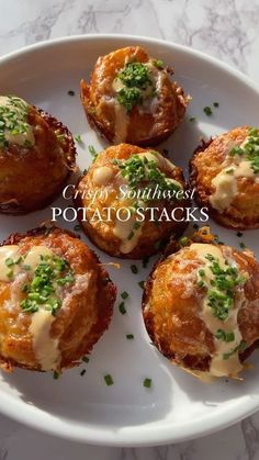 small potatoes with cheese and chives on a white plate