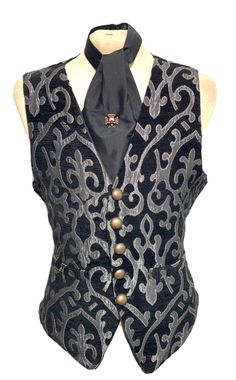 "Gothic Steampunk Black/Silver Victorian design Waistcoat & Black silk Self Tie cravat  This is very well 3 pcs outfit with Waistcoat, cravat and antique copper Tiepin. Back of the Waistcoat has waist adjuster. It has brass distressed buttons with 2 Sides pocket. It fully satin lined. Please refer to photos. Sizes Available To Fit chest  L to fit chest 42\" ( flat measurements armhole to armhole 44\" ) Front length 23\" Back length 22\" Thank you for your looking." Fitted Black Vest For Costume, Black Fitted Steampunk Vest, Gothic Black Vest For Costume, Black Gothic Costume Vest, Elegant Black Vest For Costume Party, Steampunk Style Black Vest For Costumes, Black Elegant Vest For Costume, Elegant Black Vest For Costume, Steampunk Gentleman