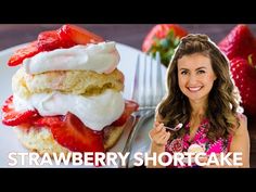 a woman holding a fork next to a strawberry shortcake