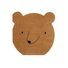 a brown bear shaped coaster sitting on top of a white surface