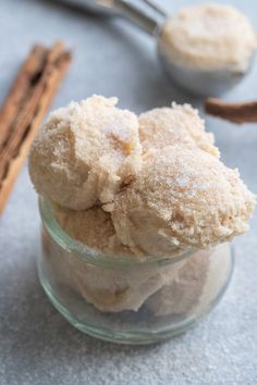 cinnamon sugar in a glass jar with cinnamon sticks next to it