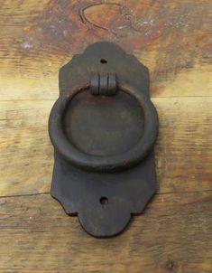 an old door handle on a wooden surface