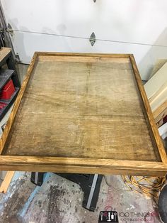 an old wooden table is being worked on