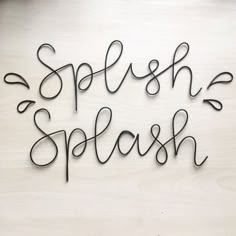 the word splash written in cursive writing on a white background