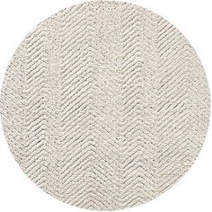 a round rug with white chevrons on the bottom, and an oval pattern in the middle