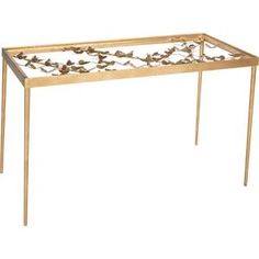 a gold metal table with leaves on it