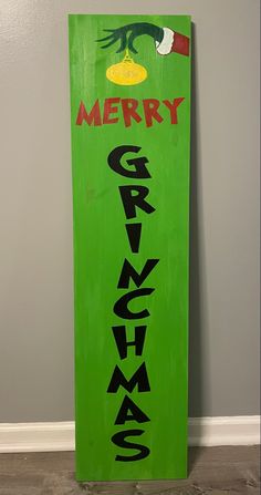 a green sign with the words merry and grino painted on it's side