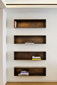 three bookshelves are lined up against the wall