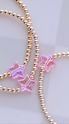 Beautiful 3mm 14kt gold filled or sterling silver ball beads accented by a hot pink iridescent star bead strung on an elastic cord. This gold bracelet will not fade or tarnish. This item is made to order so please allow 7-10 business days for item to ship. Thank you for your business and happy Shopping!! Pink Beaded Bracelets With Star Charm, Gold Bracelets With Star Charm And Round Beads, Bracelet Star, Armband Gold, Gold Armband, Star Bracelet, Bead Stringing, Bracelet Argent, Bracelet Gold