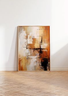 an abstract painting on the wall next to a wooden floor in a room with hard wood floors