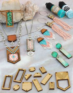 various wooden jewelry pieces are displayed on a table next to some beads and other items