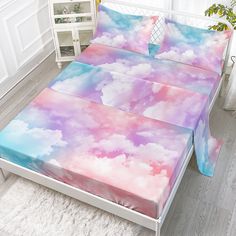 a bed with clouds on it in a room