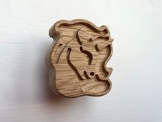 a wooden stamp with the shape of a lion on it's face is shown