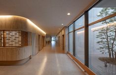 an empty hallway with wood and glass walls