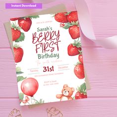 a pink birthday card with a teddy bear and balloons on it, sitting next to a pair of scissors