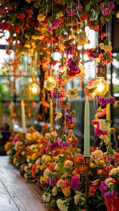 flowers and candles are hanging from the ceiling