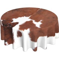 a brown and white cow print table cloth