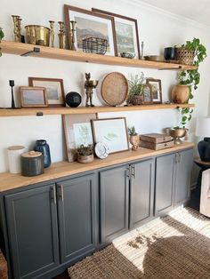 a living room with shelves and pictures on the wall