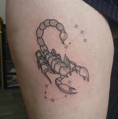 a scorpion tattoo on the back of a woman's thigh, with stars in the background