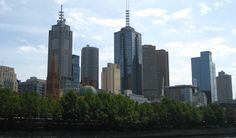 the city skyline is seen from across the river