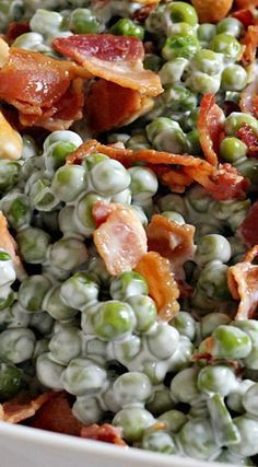 peas and bacon are mixed together in a white bowl with other foods on the side