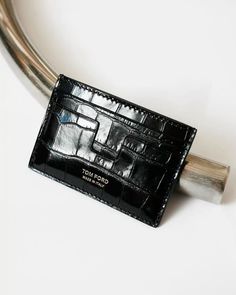 a black card holder sitting on top of a white table