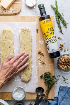 a person is making some bread on a cutting board next to other ingredients and utensils