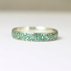 Sterling Silver Swirl / Feather Ring - Glowing green and silver ring - Your choice of Nano Ceramic Color. (see the third photo) - Comes in a cute box ready for gift giving. - Made to order, just for you. These rings are handcrafted using a sterling floral pattern. Each ring has a Green nanoceramic coating applied to the outside of the ring. I then remove a portion of the coating from the outside to highlight the beauty of the coin. I offer Sizes 2-16 for this ring, if you would like smaller size Jewellery Manufacturing, Stacked Rings, Silver Flower Ring, Green Ring, Sterling Silver Jewelry Rings, Romantic Boho, Feather Ring, Ceramic Color, Swirl Ring