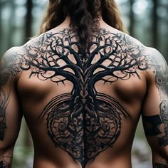 the back of a man's body with tattoos on his chest and tree tattoo