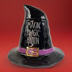 a black witches hat with the words makin'magic halloween on it and a purple band around the brim