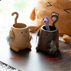 two wooden mugs sitting on top of a table