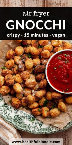 a plate full of fried gnocchini next to a bowl of tomato sauce