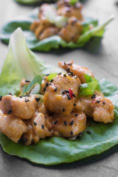 some type of food that is on top of a green leafy plate with lettuce