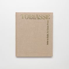 a book with the title toebasee written in green ink on top of it