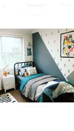 a bed room with a neatly made bed next to a window and a painting on the wall