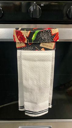 a kitchen towel hanging on the oven door