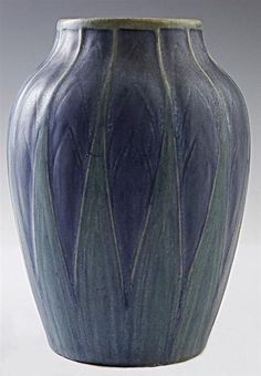 a large blue vase sitting on top of a table