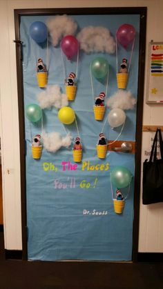 a classroom door decorated with balloons and people floating in the sky on ice cream cones