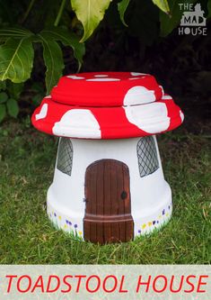 a red and white mushroom shaped house sitting in the grass with text overlay reading toad's tool house