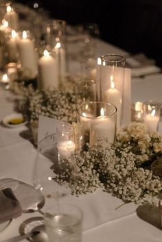 a long table with candles and flowers on it