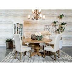 a dining room table with white chairs around it