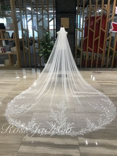 a white wedding veil with the word rose written on it in front of a doorway